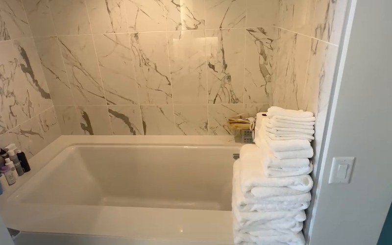 Deep-cleaned bathtub with folded towels